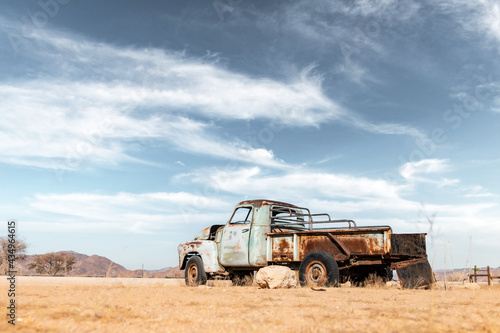 Abandoned derelict old car in the sandy desert © Ivan Kmit