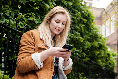 Portrait of a young woman using her smartphone.