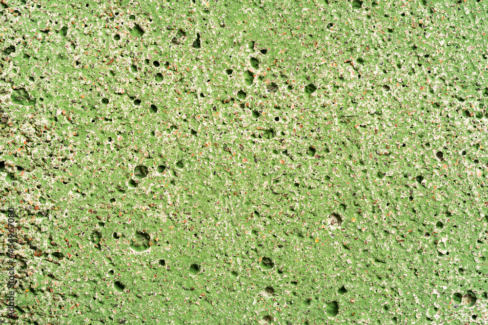Concrete wall painted in green color. Close up view Concrete wall painted in green color. Close up view