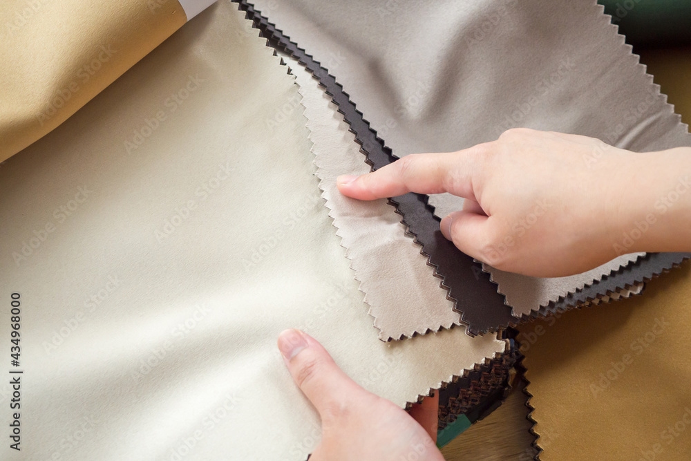 female designer with fabric color samples choosing textile for curtains female designer with fabric color samples choosing textile for curtains