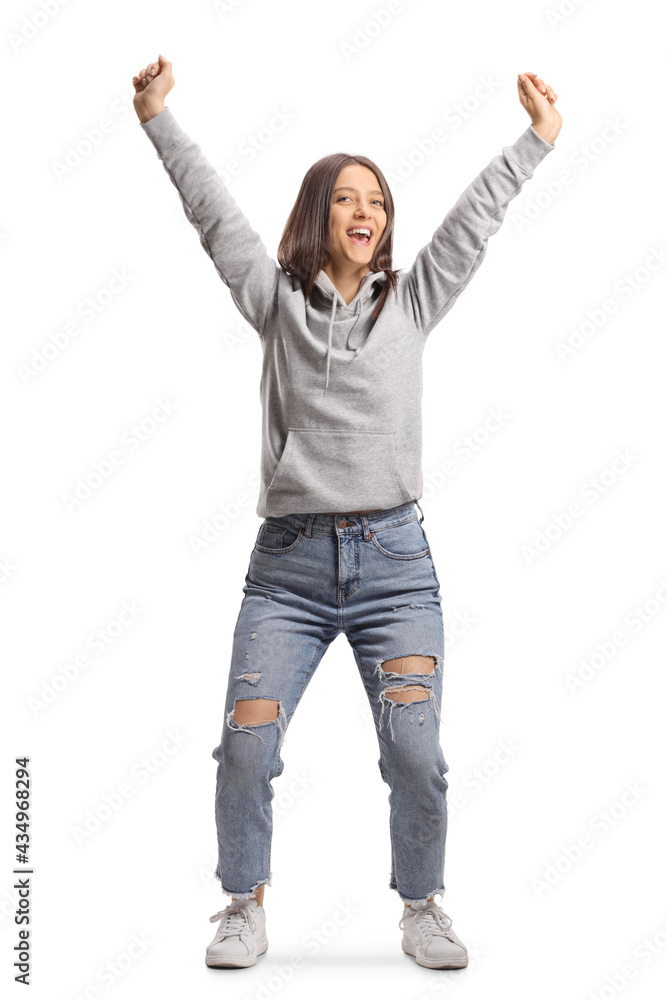 Full length portrait of an excited teenage girl jumping and gesturing happiness Full length portrait of an excited teenage girl jumping and gesturing happiness