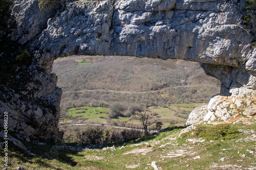 Flowers in spring  and natural stone arch in northern Spain