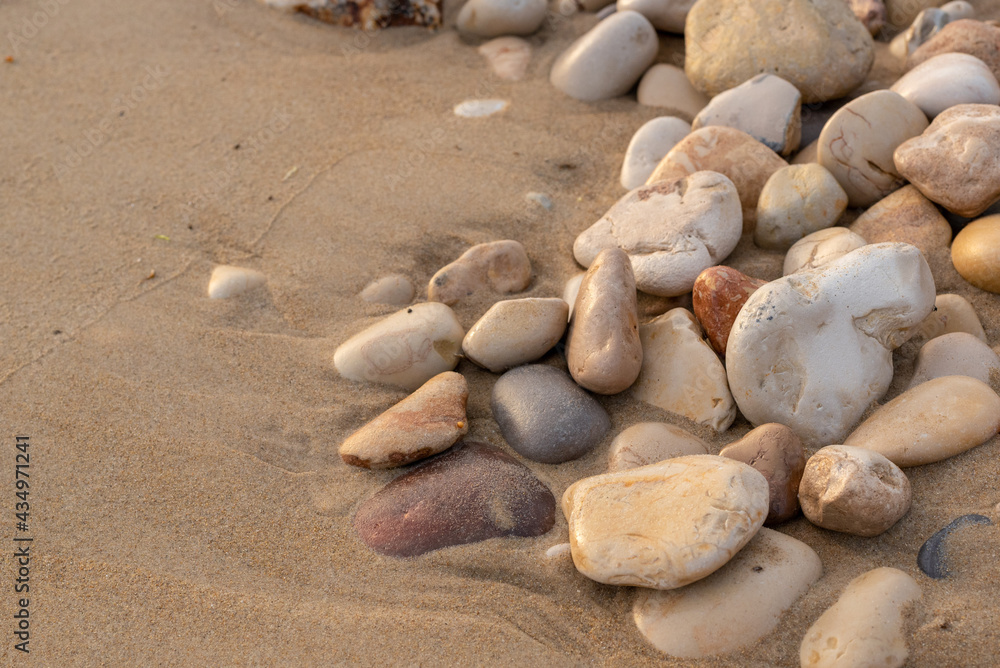 Some rocks on the Mediterranean beach. Close up with sand and smooth rounded rocks
Some rocks on the Mediterranean beach. Close up with sand and smooth rounded rocks
