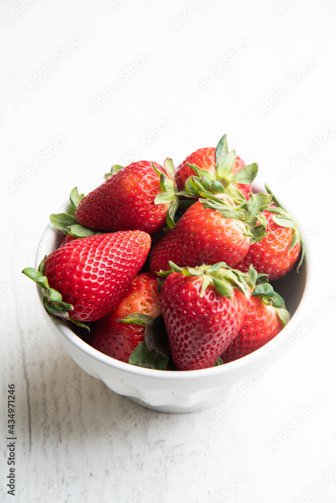 strawberry in white bowl on white background strawberry in white bowl on white background