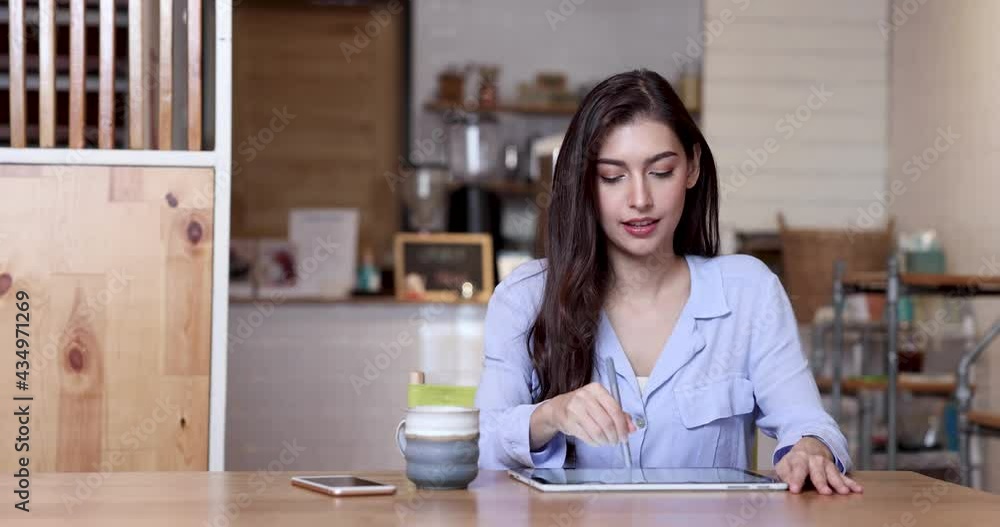Businesswoman working in coffee shop with equipment and tablet computer. Businesswoman working in coffee shop with equipment and tablet computer.