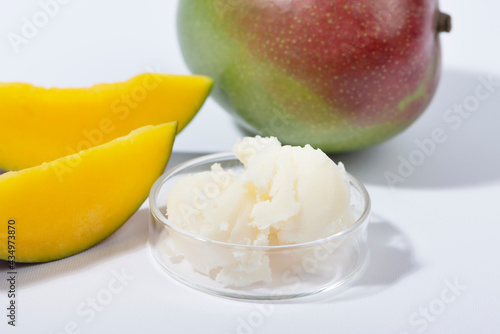 Mango butter and fresh mango fruit. Organic cosmetic, skin care, spa concept.