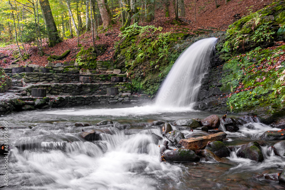 Obraz premium Waterfall with a powerful white stream of water, from which the river Lumshork originates