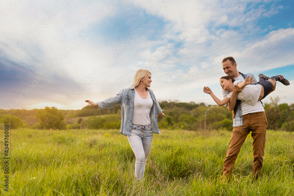 Young happy family in a field Young happy family in a field