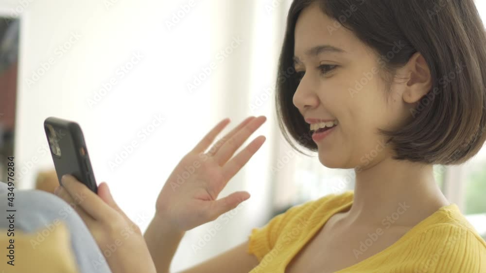 4K Young beautiful Asian couple love friend woman video call talking and Wave goodbye on sofa at home which smiling and felling happy, LGBT woman love Travelling summer vacation trip concept. 4K Young beautiful Asian couple love friend woman video call talking and Wave goodbye on sofa at home which smiling and felling happy, LGBT woman love Travelling summer vacation trip concept.