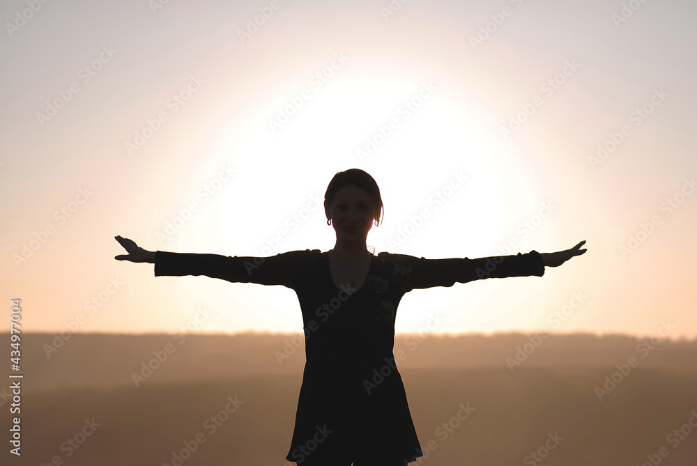 silhouette of woman holding hands up
