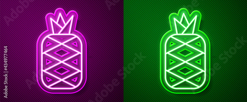 Glowing neon line Pineapple tropical fruit icon isolated on purple and green background. Vector