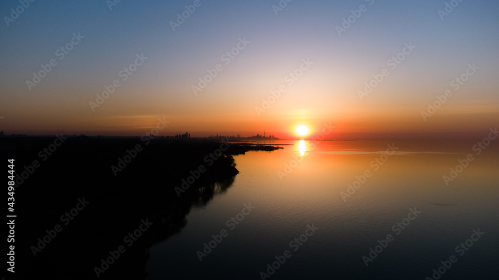 Fototapeta premium Golden Hour Sunrise sunset on the lake with orange sky 