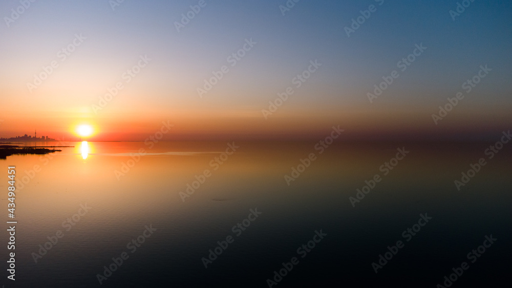 Golden Hour Sunrise sunset on the lake with orange sky 