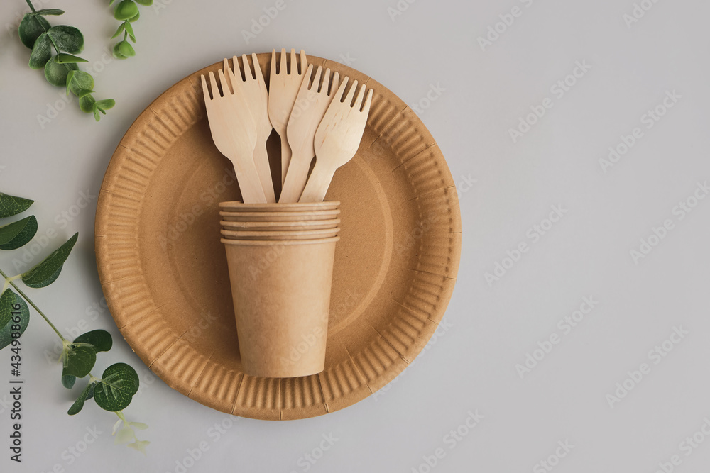 Eco friendly craft paper tableware with monstera leaf. Zero waste theme. Eco friendly craft paper tableware with monstera leaf. Zero waste theme.
