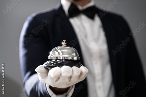 Fotografie, Obraz Hospitality Service Concierge In Uniforms With Butler Bell