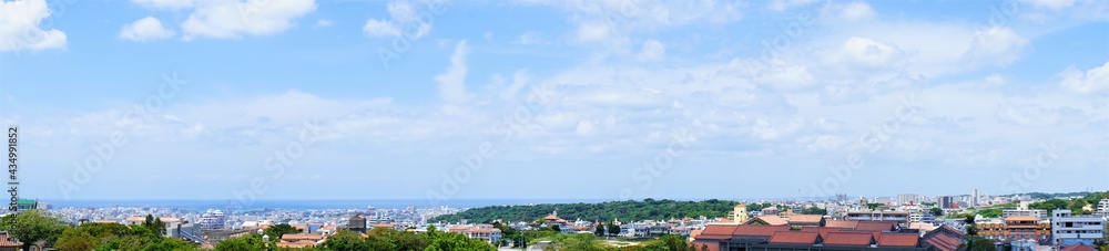 Aerial view of Naha city and sea shore from Shurijo castle in Okinawa, japan. Panorama - 沖縄 那覇市の街並みと海