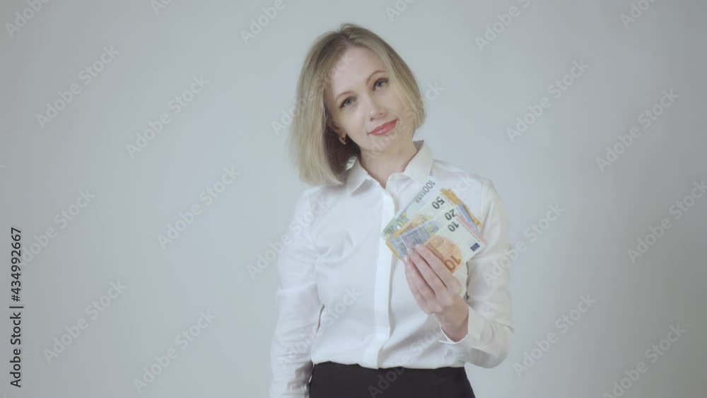 Blonde woman, bank employee throws euro in the air and choose card instead cash on white background. 4k video. Blonde woman, bank employee throws euro in the air and choose card instead cash on white background. 4k video.