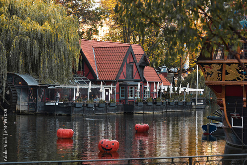 Halloween decoration at Tivoli in Copenhagen, Denmark. . High quality photo Halloween decoration theme in an outdoor public garden, scary pumpkins on the ground. photo