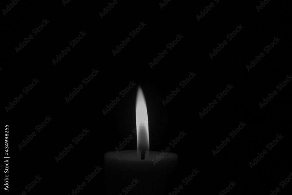 Candle flame close up on black background. Black and white photo. Candle flame close up on black background. Black and white photo.