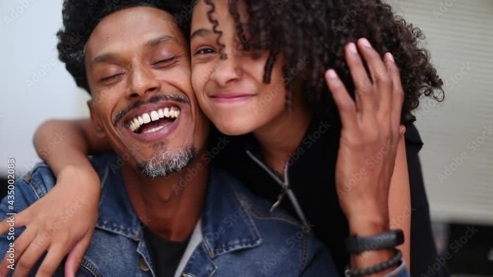 Happy daughter embracing father, black dad and little preteen girl love and affection Stock Video | Adobe Stock