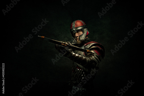 Photographie Portrait of a medieval fighter holding a crossbow in his hands