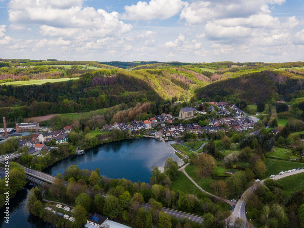 Aerial view of the monastery church Sankt Maria Magdalena in Wuppertal Beyenburg located behind the Beyenburger reservoir.