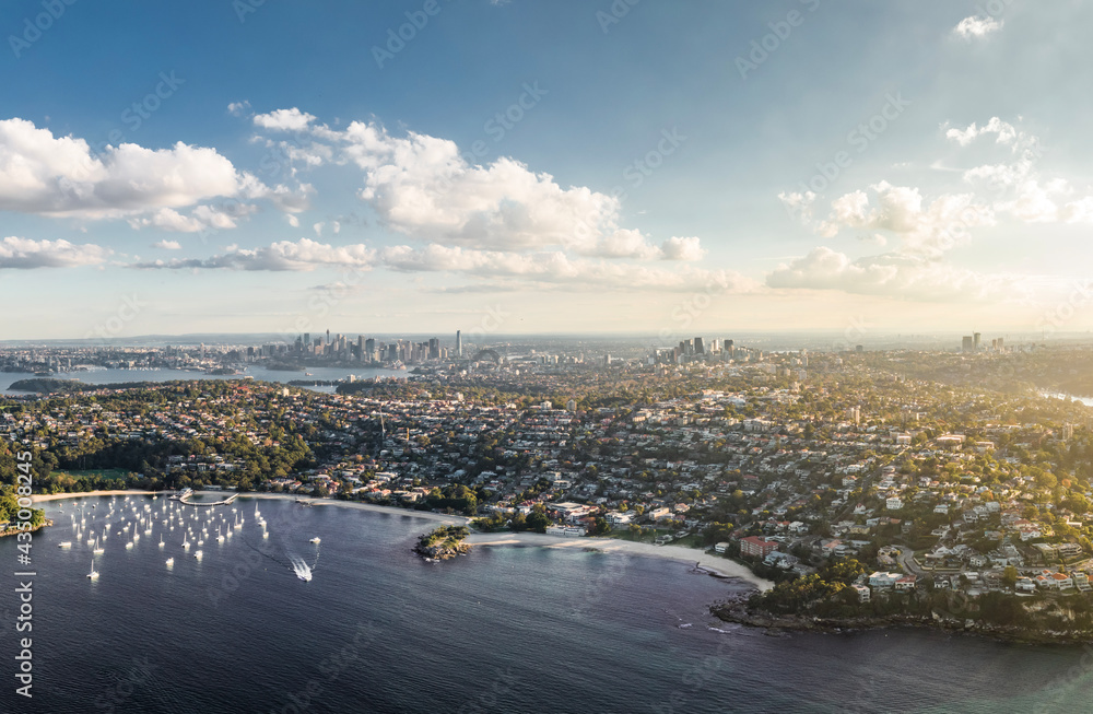 Fototapeta premium Stunning high angle aerial drone view of Balmoral Beach and Edwards Beach in the suburb of Mosman, Sydney, New South Wales, Australia. CBD, North Sydney and Chatswood in the background left to right.