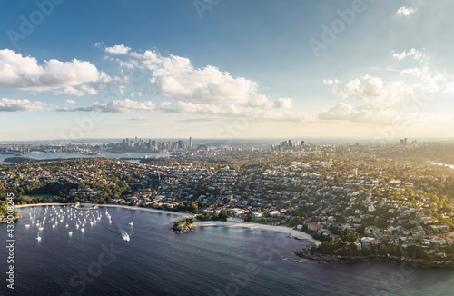 Stunning high angle aerial drone view of Balmoral Beach and Edwards Beach in the suburb of Mosman, Sydney, New South Wales, Australia. CBD, North Sydney and Chatswood in the background left to right.