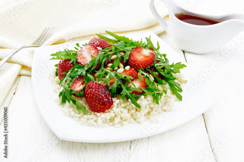 Salad of strawberry and couscous on white board