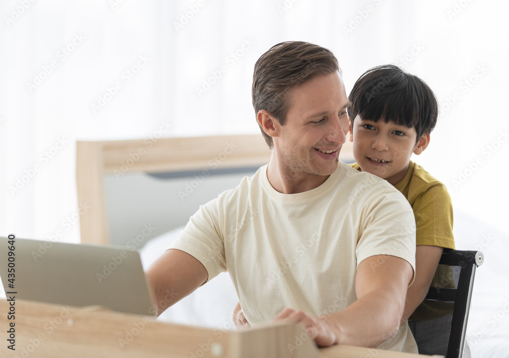 Fototapeta premium Caucasian dad and mixed-race son cuddle and playing together in fun and intimate manner