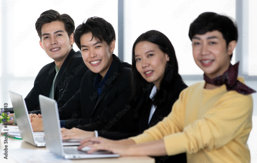 A group of multi-sex colleagues businesspeople, tomboy and transgender gay, working together with happy and intimate manner with laptop notebook computer in office A group of multi-sex colleagues businesspeople, tomboy and transgender gay, working together with happy and intimate manner with laptop notebook computer in office
