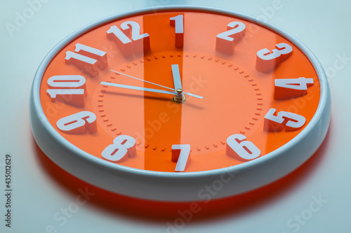 Bilde på lerret Orange clock face of a wall clock show the time