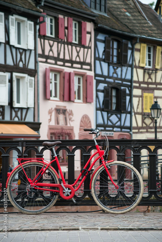 View of vintage bicycle on medieval architecture background in Colmar - France
