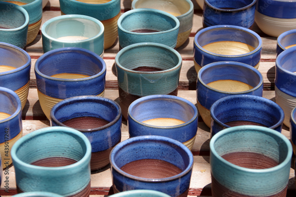 Cut out full frame you of a display of colorful flower pots for succulent plants at a cactus garden Cut out full frame you of a display of colorful flower pots for succulent plants at a cactus garden
