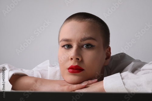 Bald woman, with pensative expression posing in the studio. Isolated. photo
