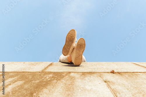 Obraz na płótnie Feet of a young woman in tennis shoes, bottom view w salonie