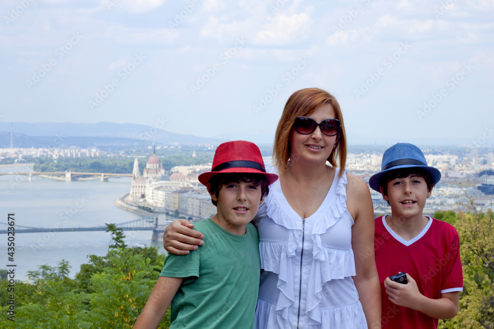 happy family smiling at camera in Budapest, Hungary in summer