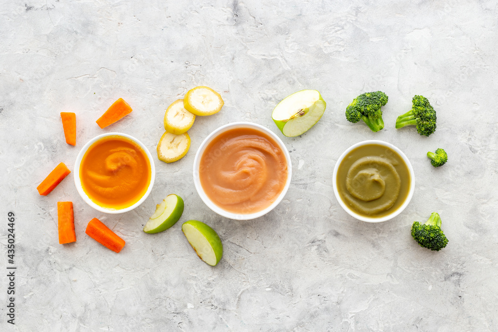 Set of bowls with baby food with fruits and vegetables. Kid feeding, top view Set of bowls with baby food with fruits and vegetables. Kid feeding, top view