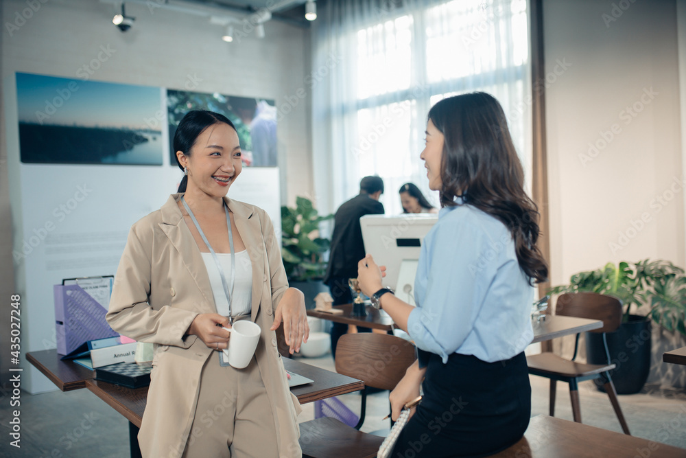 Obraz premium Asian women business team talking having fun enjoy conversation good friendly relations walking in office