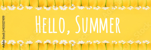 Hello Summer text and border from chamomile flowers on yellow background. Concept Welcome summer time. Banner