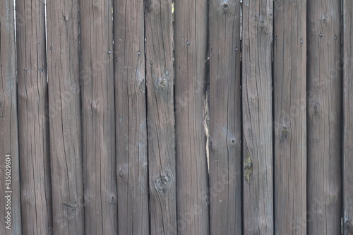 The texture of an old wooden fence made of logs. 