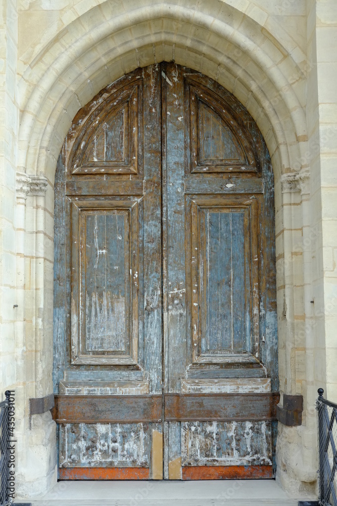 A close-up on an medieval door at the Vincennes castle in the east of Paris. Stripping work in order to renovate the peace of art.