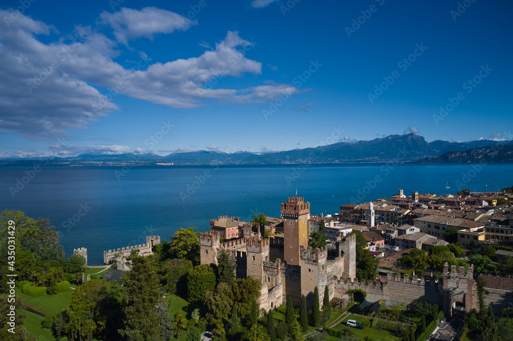 Aerial view of the Scaliger Castle of Lazise. Lazise Lake Garda Italy. Top view of the historic part of the city Lazise Castle on the coastline of Lake Garda. Panorama of the historic town of Lazise