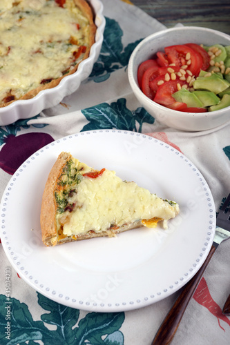 Kish. Homemade pie with scrambled eggs, vegetables and cheese.