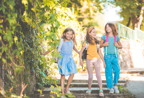 Three little girls going to school.