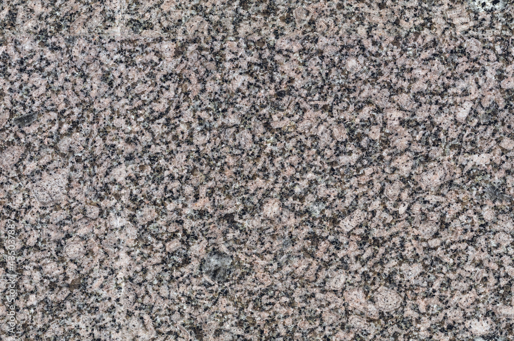 seamless mottled gray and beige granite texture with dark blue splashes. stone surface seamless mottled gray and beige granite texture with dark blue splashes. stone surface