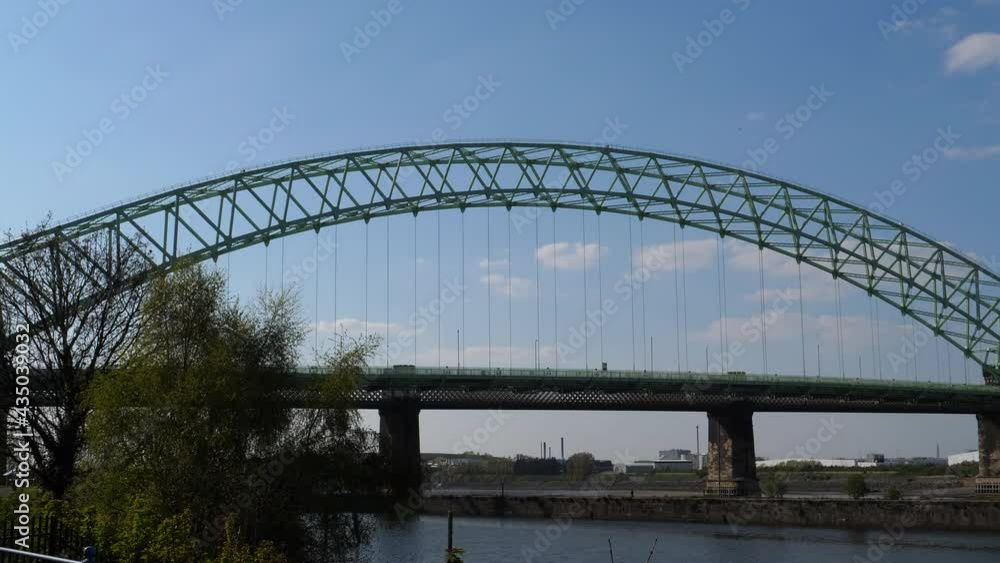 Silver Jubilee Bridge and railway bridge pan from Runcorn to Widnes. It's a toll bridge over River Mersey and Manchester Ship Canal in North West of England, United Kingdom. Silver Jubilee Bridge and railway bridge pan from Runcorn to Widnes. It's a toll bridge over River Mersey and Manchester Ship Canal in North West of England, United Kingdom.