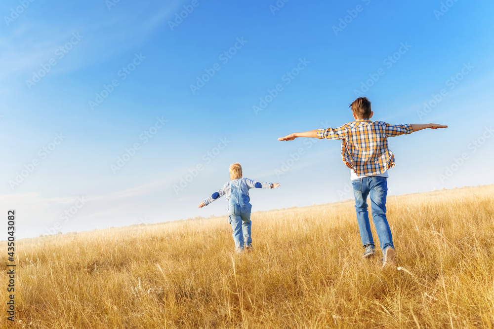 Boys are running on the grass in the open air.