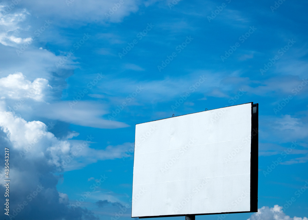 Empty billboard against blue sky with clouds Empty billboard against blue sky with clouds