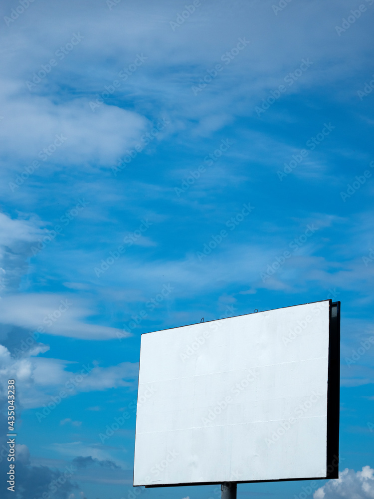 Empty billboard against blue sky with clouds Empty billboard against blue sky with clouds